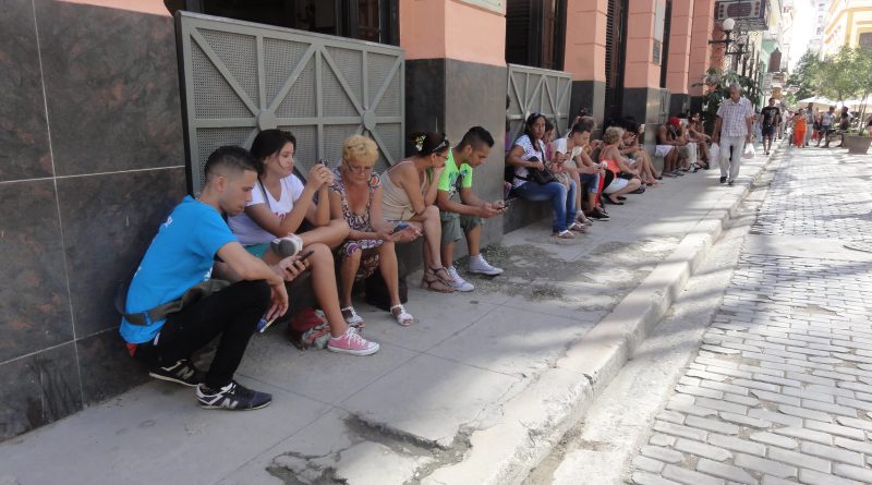 Photo by Othmark of people in Havana, Cuba using a Wifi hotspot to access the internet.