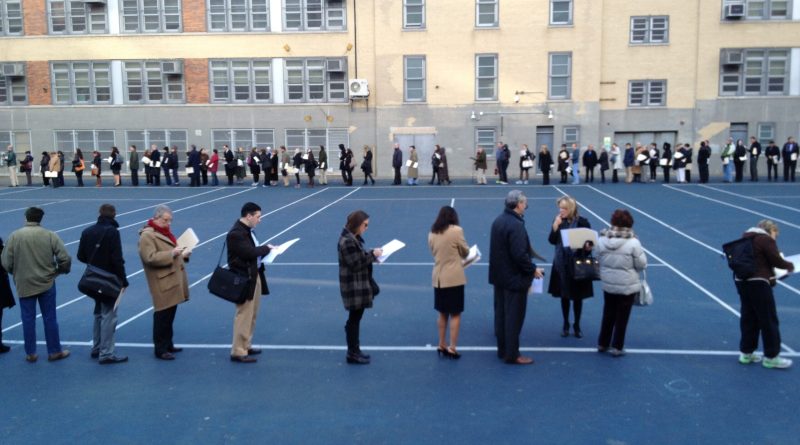 long voting line in front of a middle school